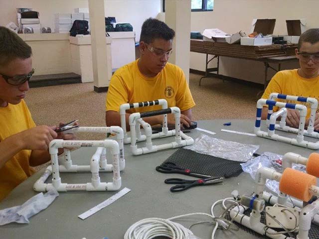 6745693_orig Hiram House campers building a project from PVC pipe
